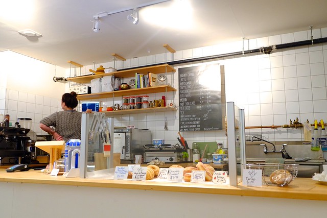 Paper Crane Coffee counter with pastries and chalkboard menu