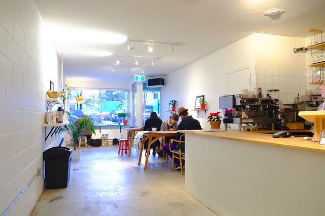 Paper Crane Coffee interior with tables and plants